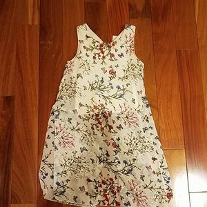 White tank with floral tunic.